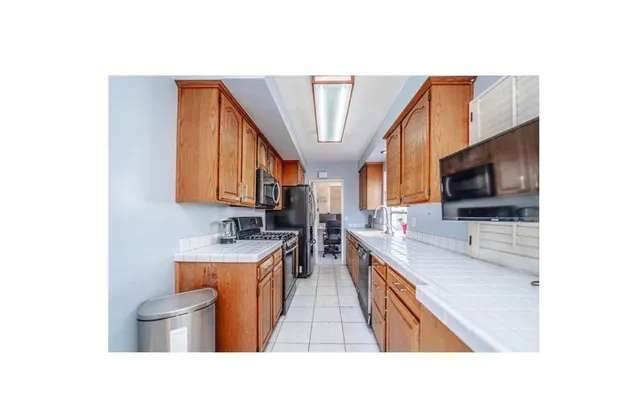 a bathroom with a granite countertop sink a mirror and a bathtub