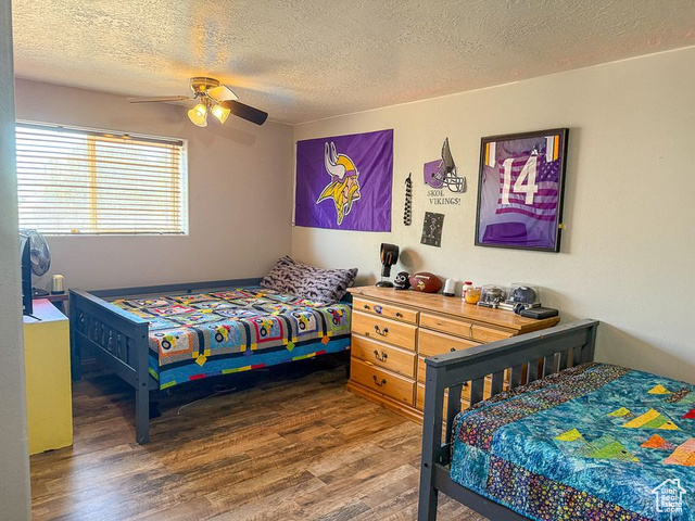 425 East Mule Deer Road Central, UT 84722 - Photo 23 of 72 Bedroom with wood finished floors, a textured ceiling, and ceiling fan