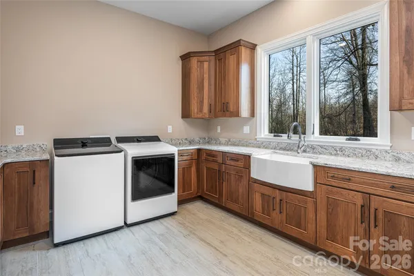 a kitchen with granite countertop white cabinets and white appliances