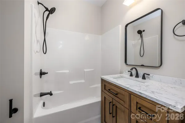 a view of a hallway with wooden floor and entryway