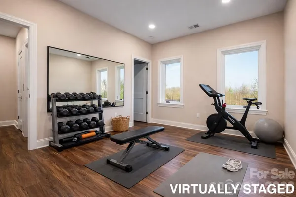 a living room with furniture fireplace and a large window