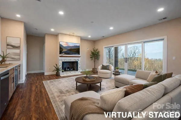 a view of a big room with wooden floor a fireplace and window