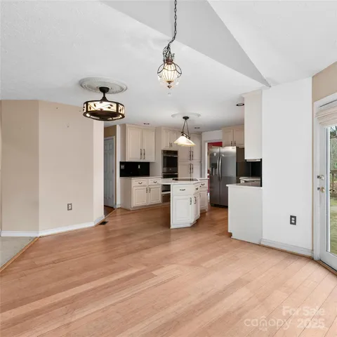 a view of a kitchen with a sink and a refrigerator
