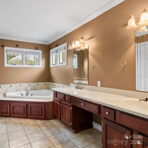 a spacious bathroom with a sink double vanity and a mirror