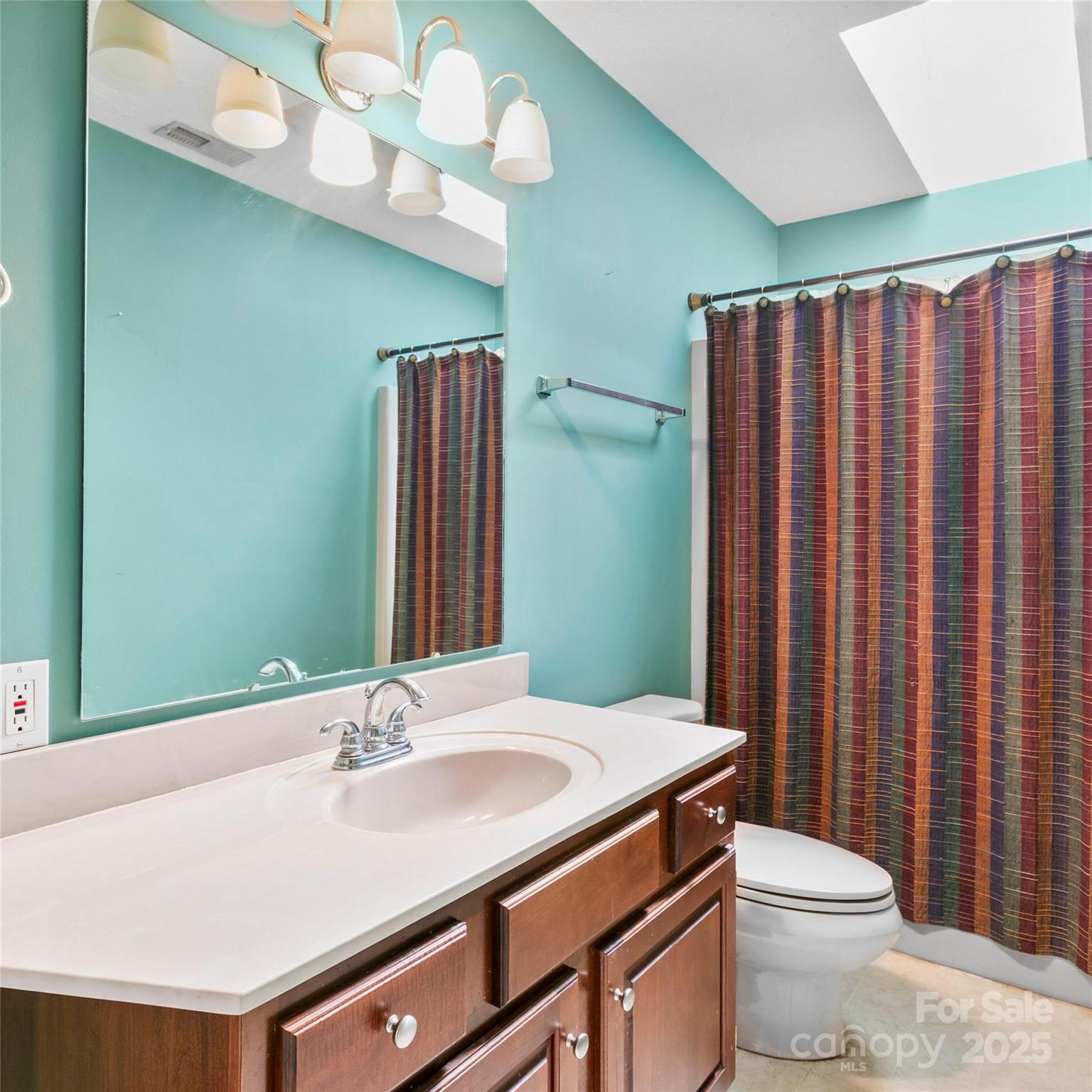 2 Sun Up Lane Candler, NC 28715 - Photo 26 of 30 a bathroom with a sink a toilet and mirror