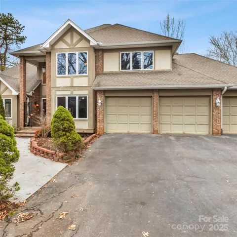 a view of a white house with large windows