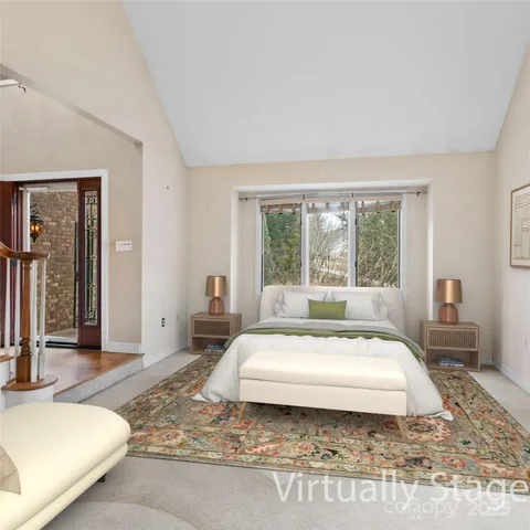 a spacious bedroom with a large bed and a large window