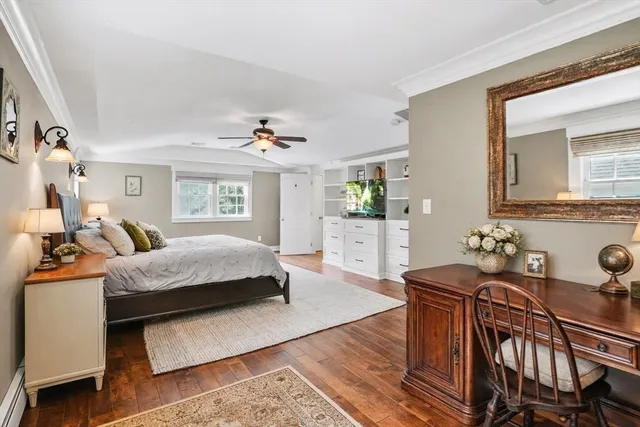 a bedroom with furniture and a wooden floor