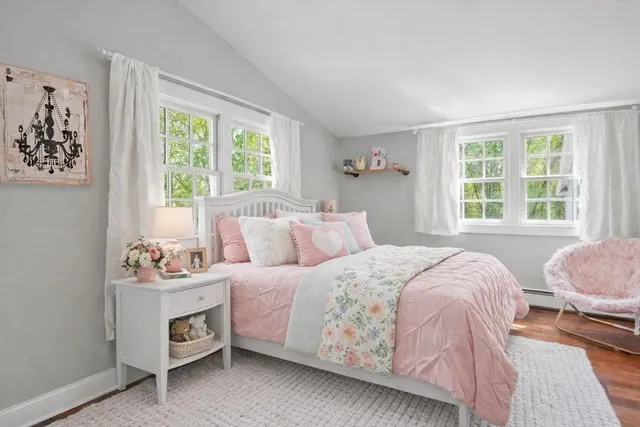 a bedroom with two beds and a window