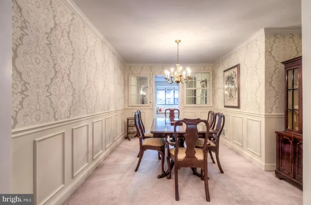 a view of a dining room with furniture and chandelier