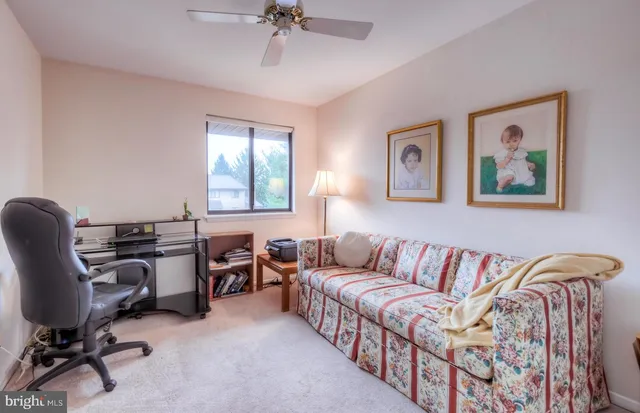 a view of a livingroom with workspace and a couch