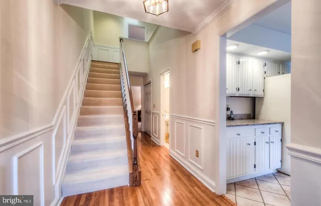 a view of a kitchen with wooden floor and staircase