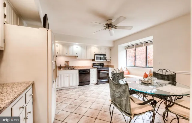 a kitchen with stainless steel appliances kitchen island granite countertop a refrigerator a stove a sink dishwasher with a dining table and chairs