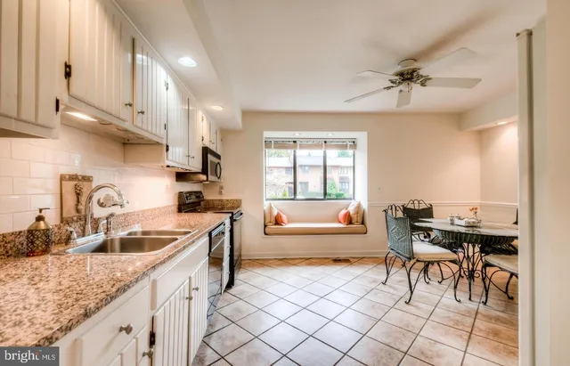 a kitchen with granite countertop a sink and a stove
