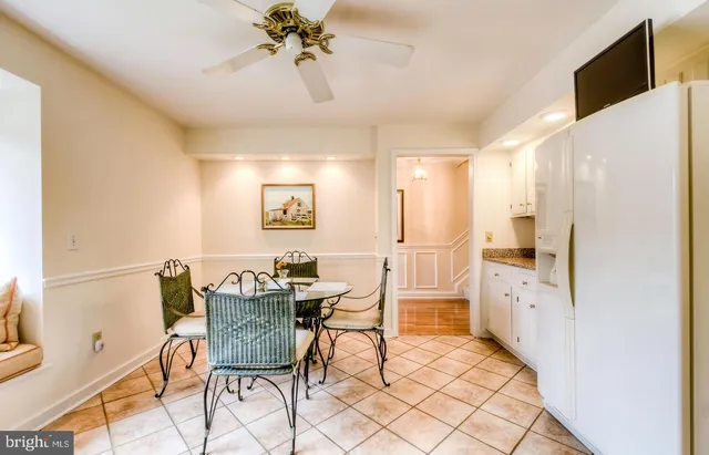 a view of a dining room with furniture and a chandelier