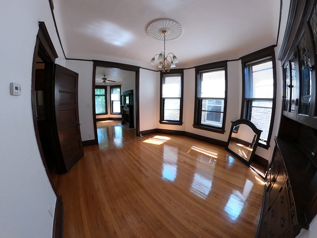 3018 North Racine Avenue, Unit 3F Chicago, IL 60657 - Photo 3 of 10 a view of a livingroom with furniture hardwood floor and staircase