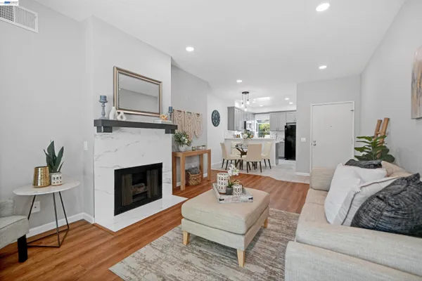 a living room with furniture a fireplace and a table