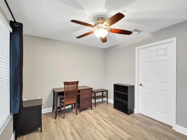 a view of a livingroom with furniture and chandelier fan