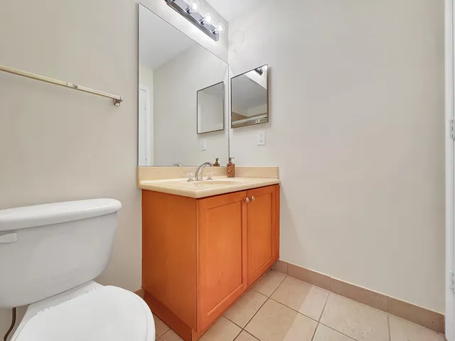 a bathroom with a sink toilet and mirror