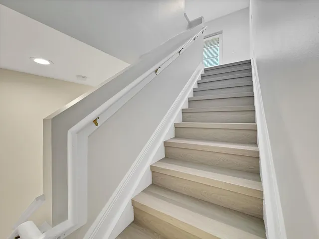 a view of staircase with white walls