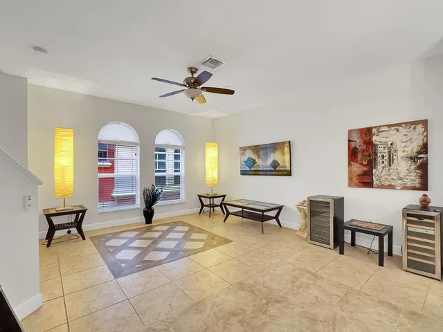 a living room with furniture a chandelier and a flat screen tv