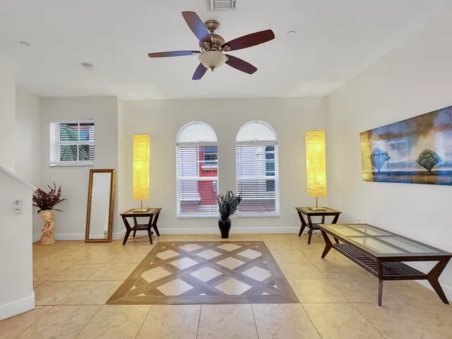 a living room with furniture a rug and a large window