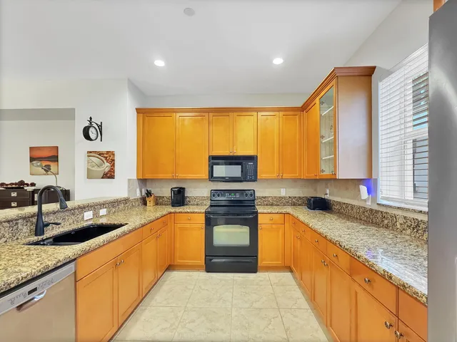 a kitchen with granite countertop a sink and counter space