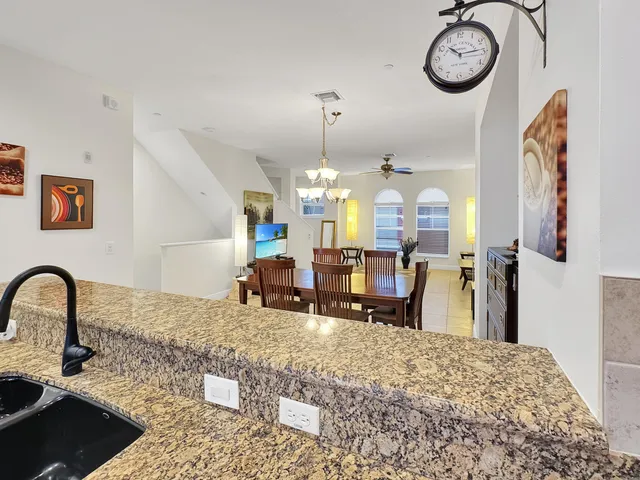 a living room with furniture a fireplace and chandelier