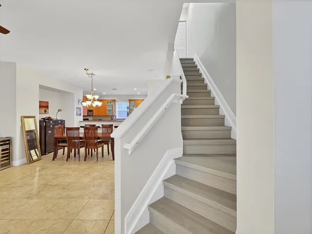a view of dining room with furniture and a chandelier