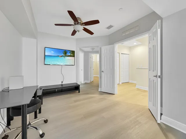 a view of a livingroom with furniture and a ceiling fan