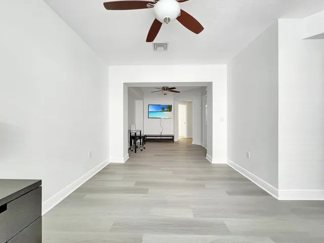 a view of a room with a ceiling fan