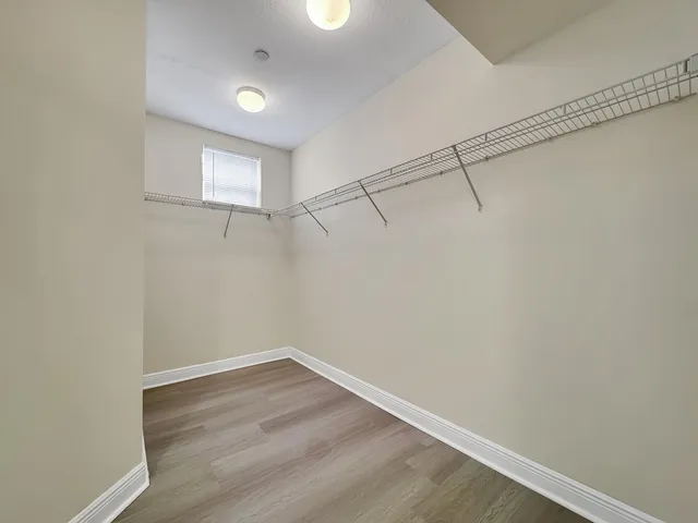a view of a room with wooden floor