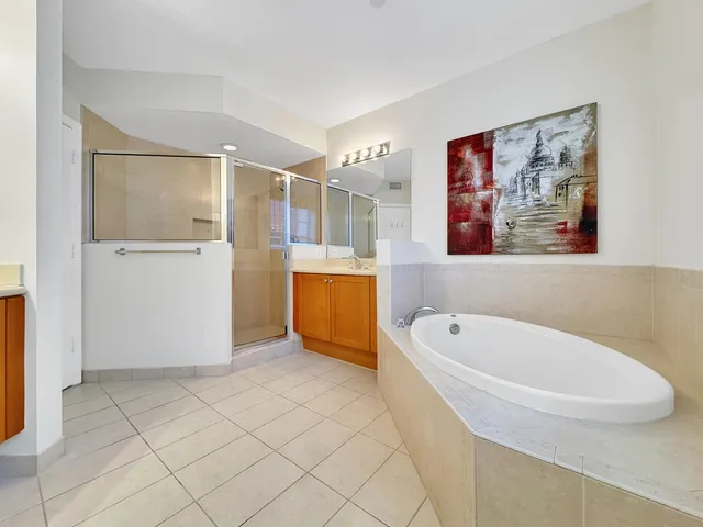a bathroom with a tub a sink and a shower