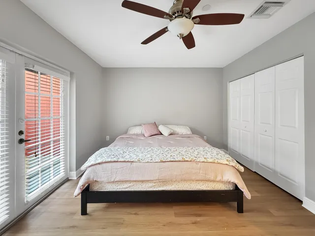 a bedroom with a bed and a ceiling fan