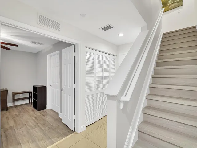 a view of entryway with wooden floor and stairs