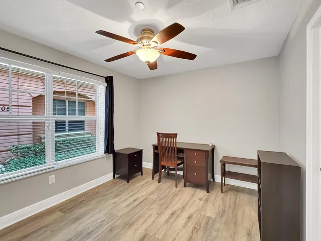 a view of workspace with wooden floor and windows