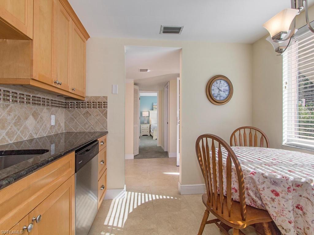 213 Quails Nest Road, Unit 1 Naples, FL 34112 - Photo 2 of 11 a bedroom with a bed and a table in it