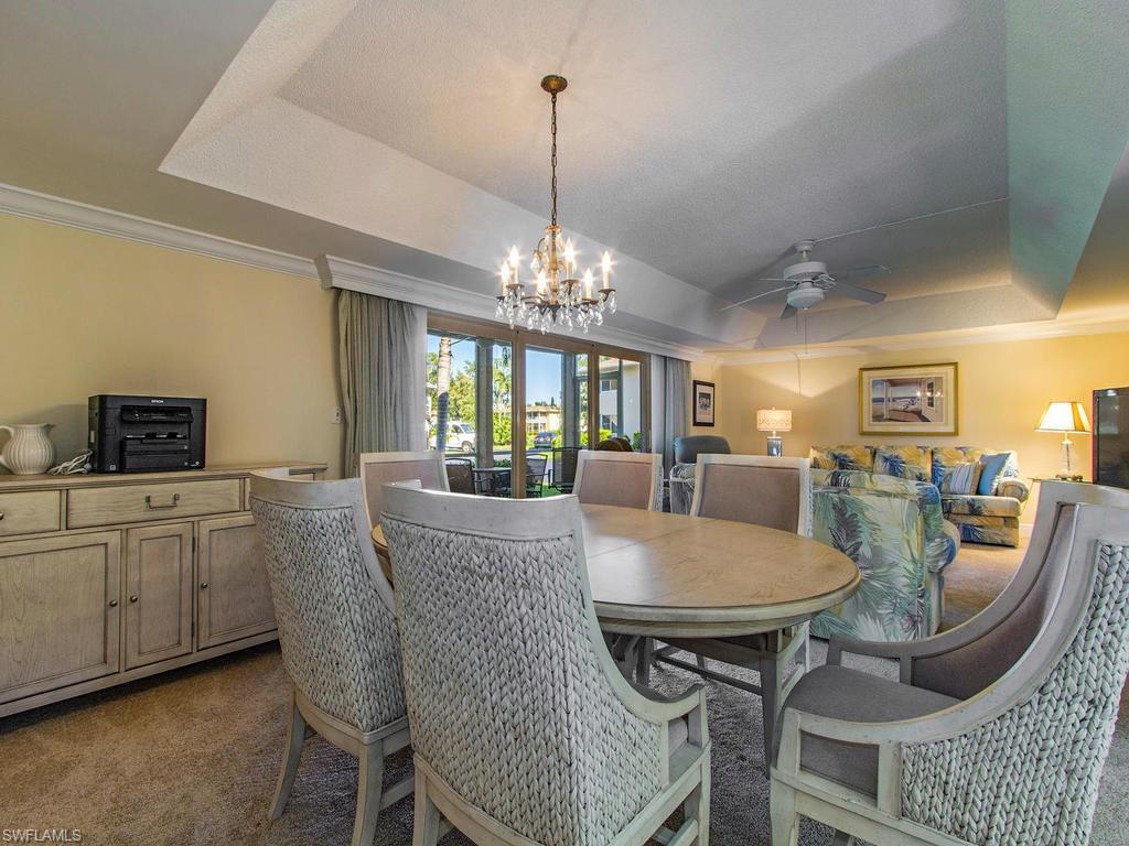 213 Quails Nest Road, Unit 1 Naples, FL 34112 - Photo 5 of 11 a view of a dining room with furniture and window