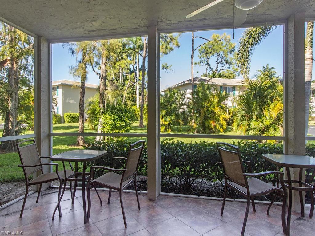 213 Quails Nest Road, Unit 1 Naples, FL 34112 - Photo 9 of 11 a view of a dining room with furniture window and outside view