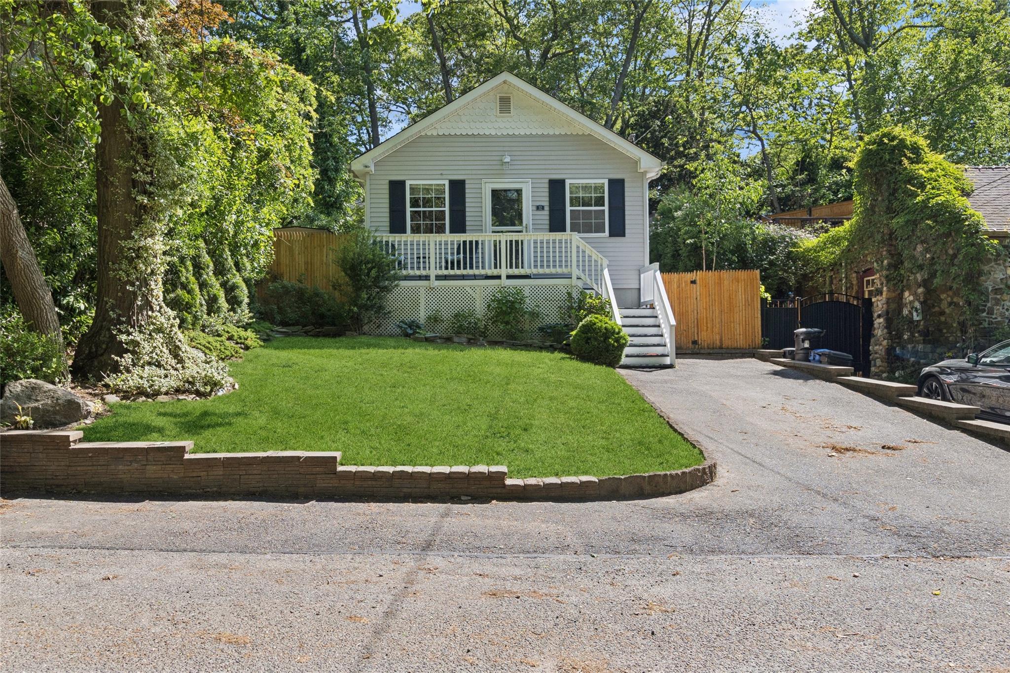 32 Flowerfield Road Sound Beach, NY 11789 - Photo 1 of 1 a front view of a house with a yard and garage