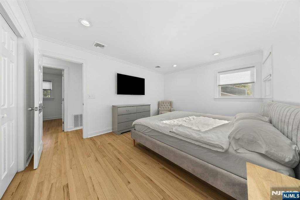 62 Sycamore Road Dumont, NJ 07628 - Photo 18 of 43 a bedroom with a bed and a flat screen tv