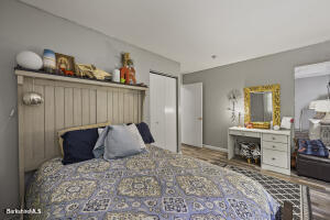 1052 Beaver Pond Road Williamstown, MA 01267 - Photo 15 of 37 a bedroom with a bed and wooden floor