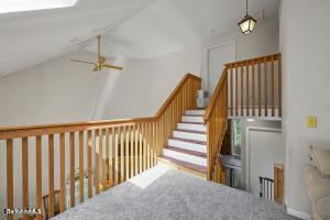 1052 Beaver Pond Road Williamstown, MA 01267 - Photo 21 of 37 a view of staircase with lots of frames on wall and a chandelier