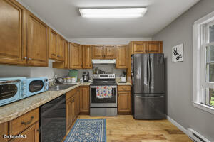 1052 Beaver Pond Road Williamstown, MA 01267 - Photo 9 of 37 a kitchen with a refrigerator stove and sink