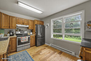 1052 Beaver Pond Road Williamstown, MA 01267 - Photo 10 of 37 a kitchen with granite countertop a refrigerator stove top oven and sink
