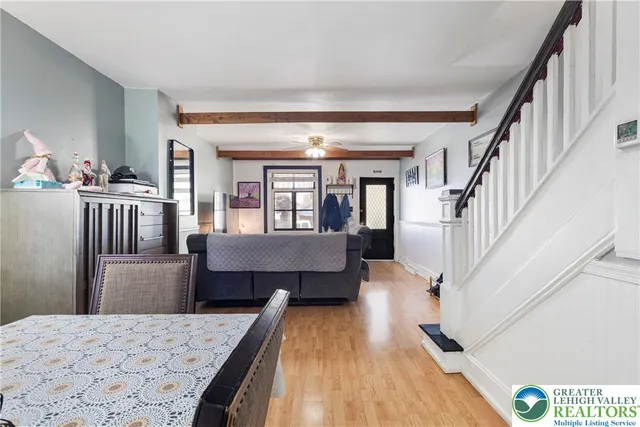 a kitchen with stainless steel appliances wooden floor and large window