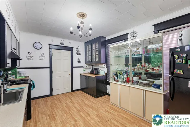 a kitchen with stainless steel appliances granite countertop a refrigerator a stove top oven a sink dishwasher and wooden floor