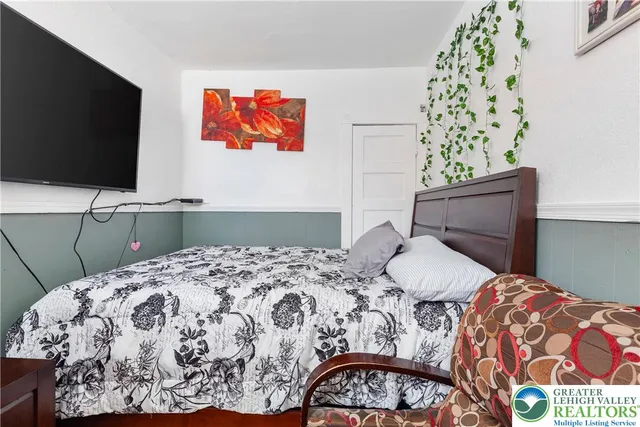 a spacious bedroom with a bed and window