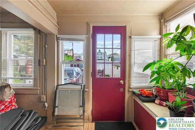 a kitchen with a potted plant on the counter and a wooden floor