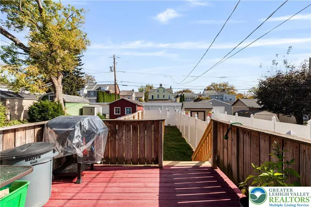 a view of a deck in front of house with a yard